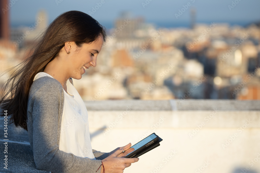Profile woman watching multimedia content using a tablet Profile woman watching multimedia content using a tablet