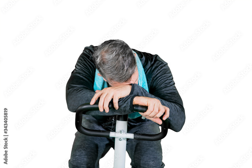 Grey hair man feeling tired on gym cycling Grey hair man feeling tired on gym cycling