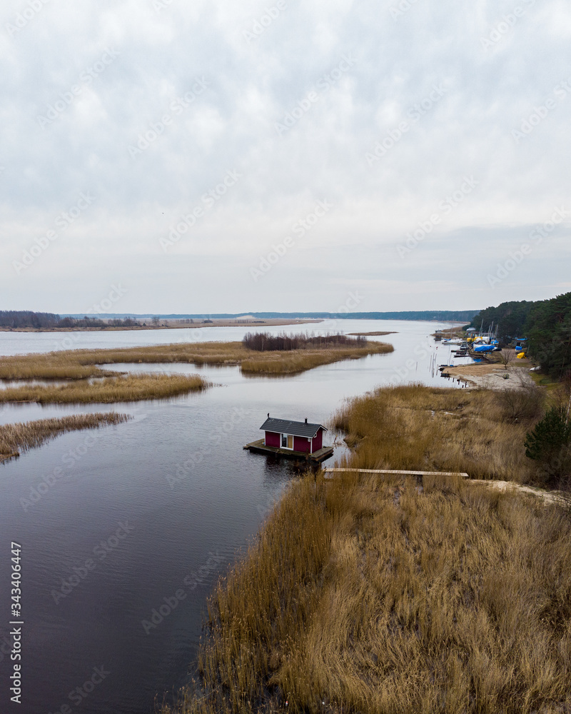 Beautiful riverside areal view of river Lielupe flowing near pine forest strees on both coast lines. Beautiful riverside areal view of river Lielupe flowing near pine forest strees on both coast lines.