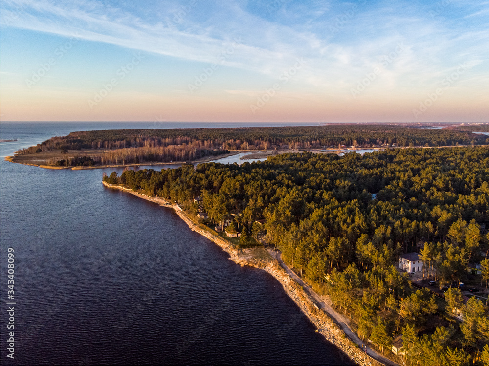 Riverside shore view of big white sand dune on a lovely evening sunset.