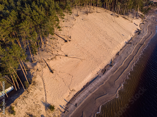 Riverside shore view of big white sand dune on a lovely evening sunset. photo