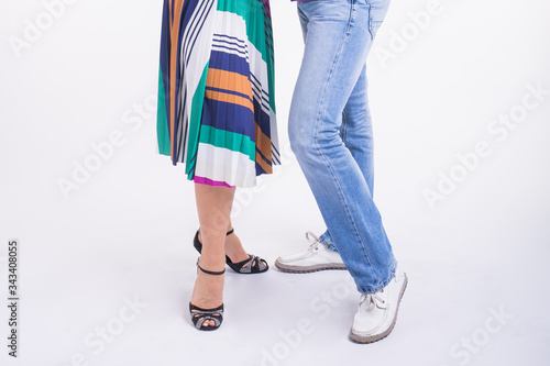 Close-up of couple dancing social dance. Kizomba or bachata or semba or taraxia , on white background. Social dance concept. photo