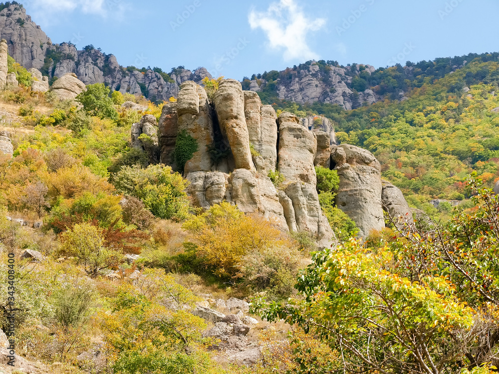 Weathered rocks among the fall forest on the mountain slope Weathered rocks among the fall forest on the mountain slope
