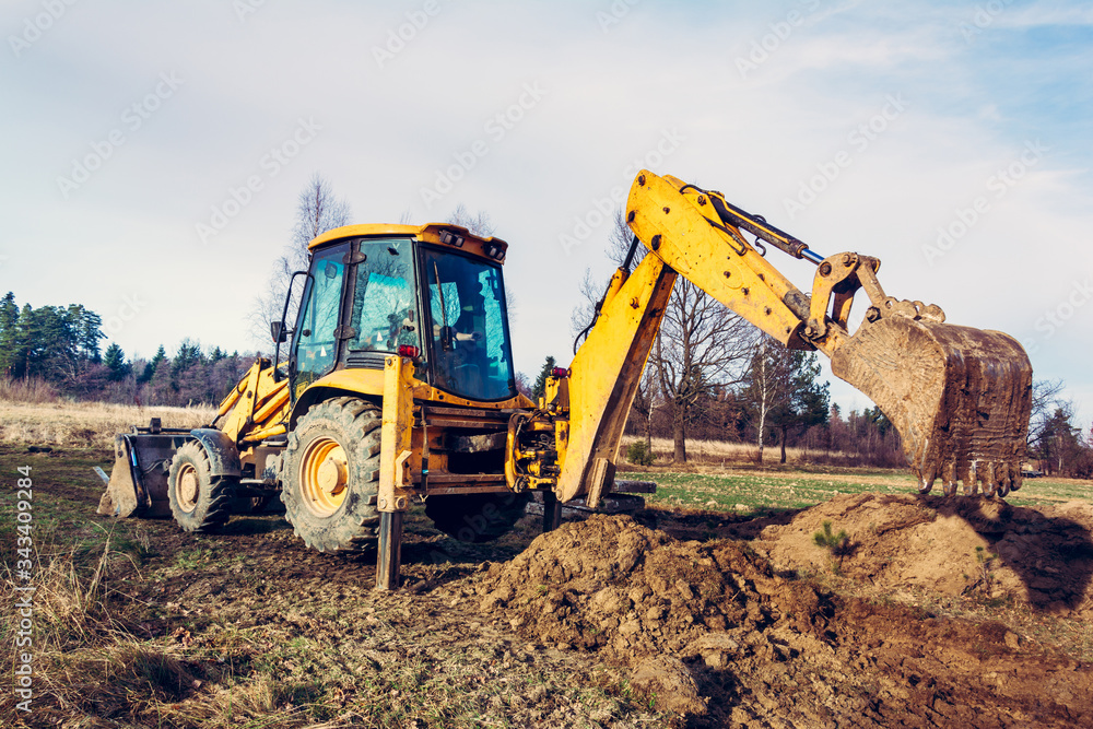 The excavator clears the ground to pave the road in private territory. The excavator clears the ground to pave the road in private territory.