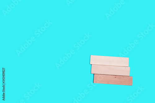 Three small wooden bars on a blue background. Space for text.