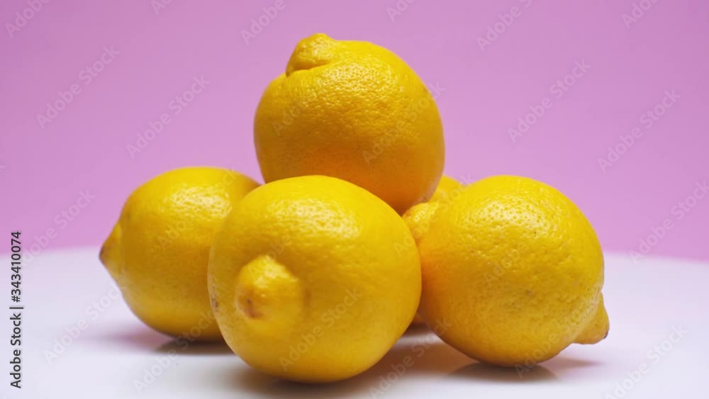 Fresh lemon isolated on a pink background. Summer and seasonal fruits for a healthy lifestyle. Healthcare. Fresh lemon isolated on a pink background. Summer and seasonal fruits for a healthy lifestyle. Healthcare.