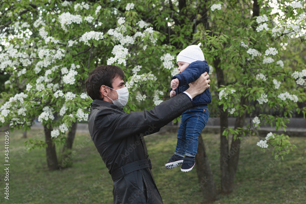 Fototapeta premium Child and man in medical protective mask on the street. Epidemic of virus covid
