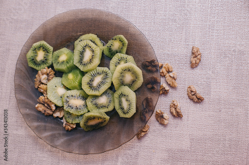 kiwi with walnuts on a plate, proper and healthy nutrition