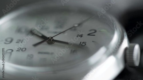 Timex watch ticking sped up to simulate time is passing quickly.
Close-up on watch face and hands.
Shot at an angle into watch face.
Shallow depth-of-field. photo