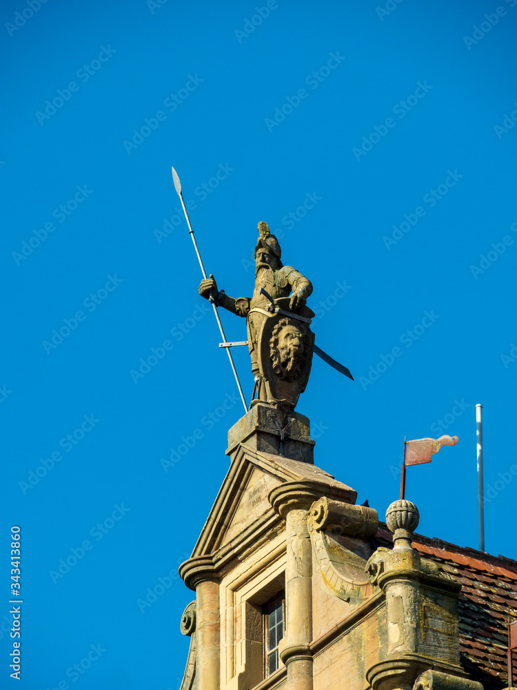 Rothenburg ob der Tauber, Germany - Feb 16th, 2019: Knight statue at Tower of Townhall of Rothenburg ob der Tauber, Germany