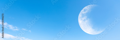 Moon and clear blue sky as background, panoramic view