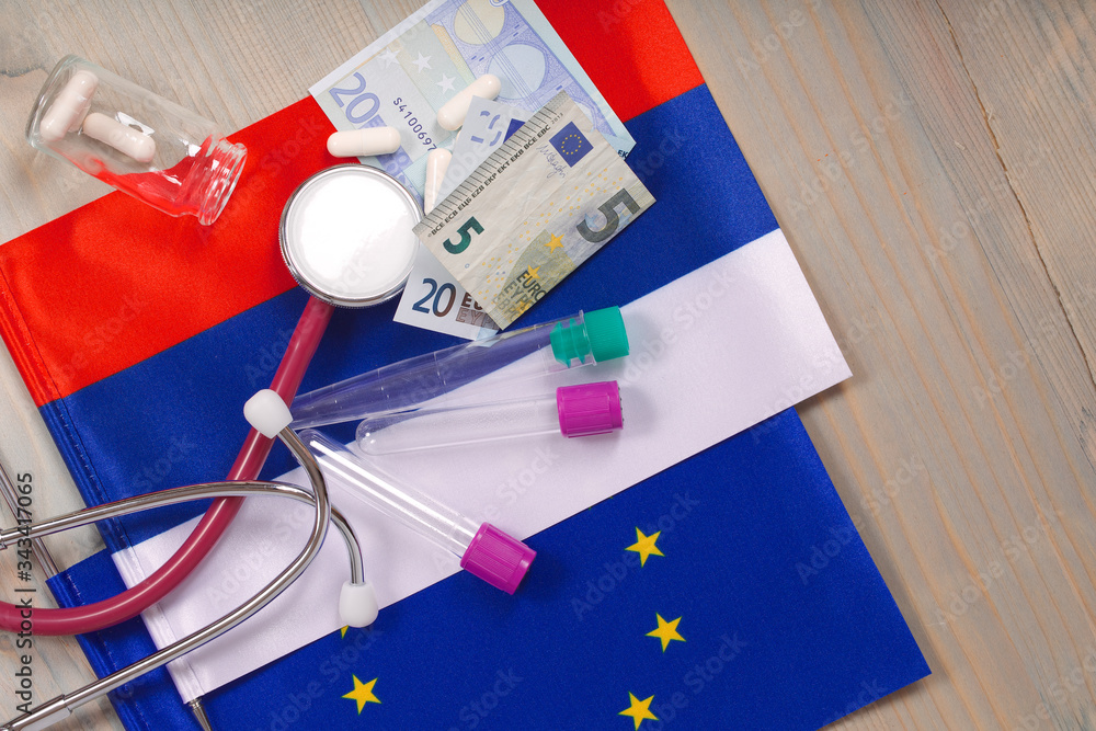 Fototapeta premium Medication,test tubes,money and stethoscope on European and Russian flags