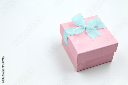 pastel colors gift box with white ribbon isolated on white background