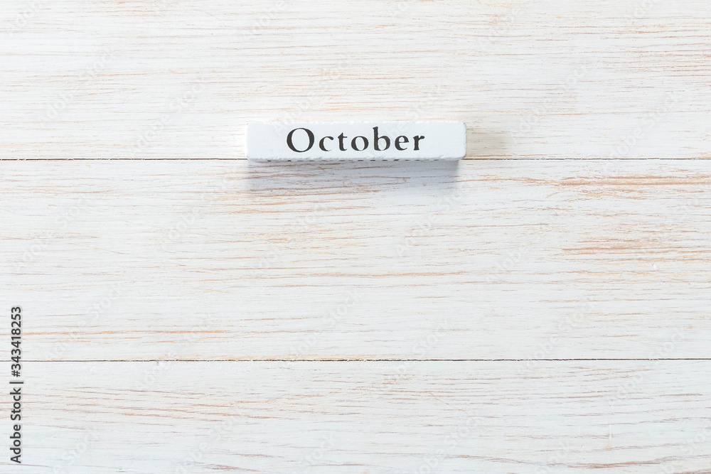 Wooden block of calendar with month October on wood background Wooden block of calendar with month October on wood background