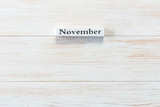 Wooden block of calendar with month November on wood background