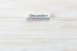 Wooden block of calendar with month December on wood background
