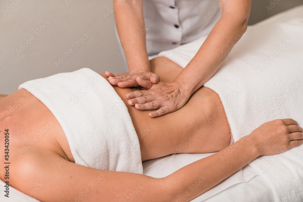 Fototapeta premium Young woman having stomach massage.