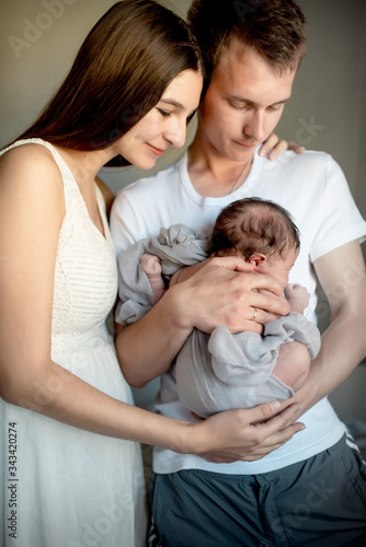 Newborn baby with mom and dad at home
