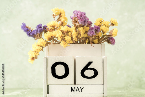 cube calendar for may on green background with copy space