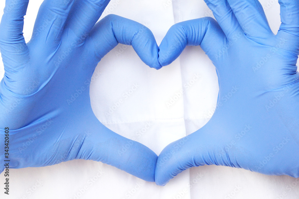 hands in latex glove shows the symbol of the heart. Doctor for the heart. Love our medical professionals. hands in latex glove shows the symbol of the heart. Doctor for the heart. Love our medical professionals.
