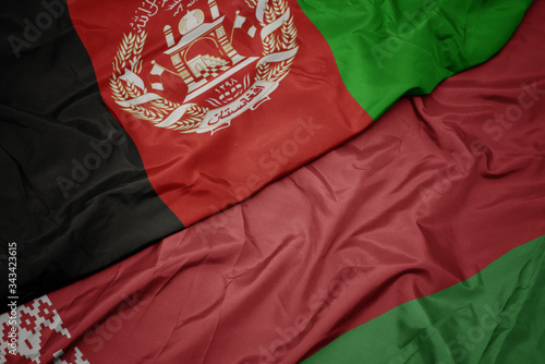 waving colorful flag of belarus and national flag of afghanistan.
