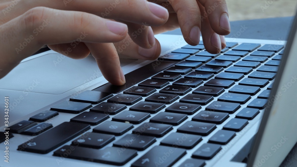 close up shot of Typing hands on laptop keyboard close up shot of Typing hands on laptop keyboard