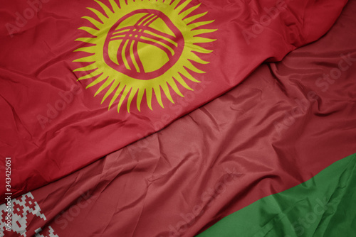waving colorful flag of belarus and national flag of kyrgyzstan.