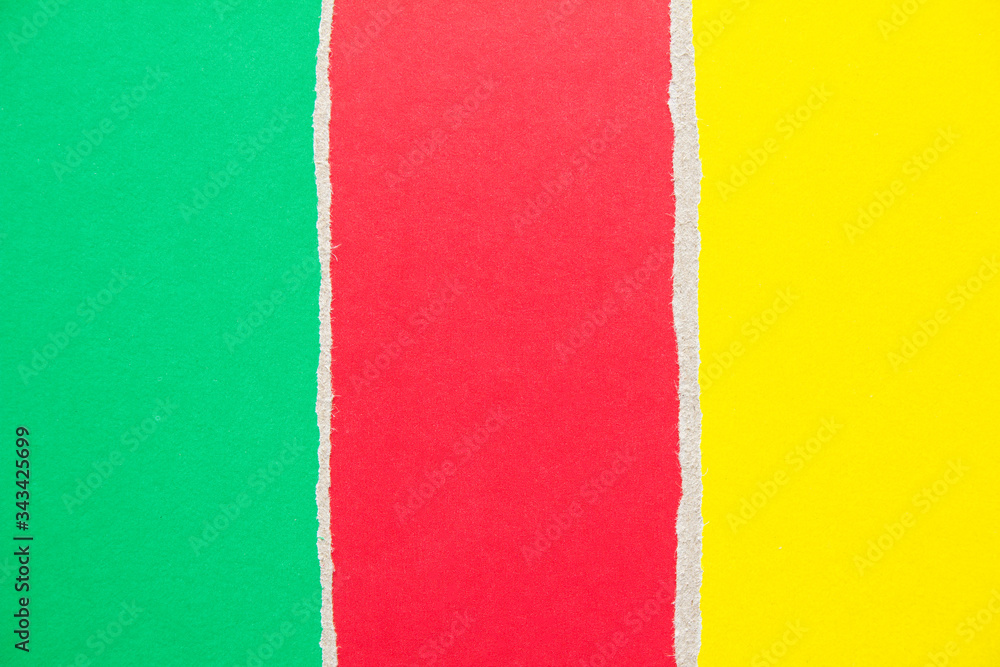 Fototapeta premium Red, green and yellow ripped pieces of cardboard paper texture background. Copy space for text message.