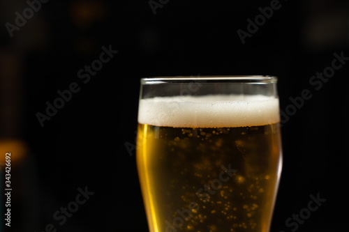 Close-up of goblets with pouring beer