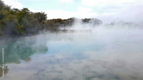 Steams rising from a hot volcanic lake in Rotorua New Zealand