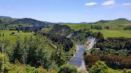 Scenic landscape with mountains and bridge crossing a river in New Zealand