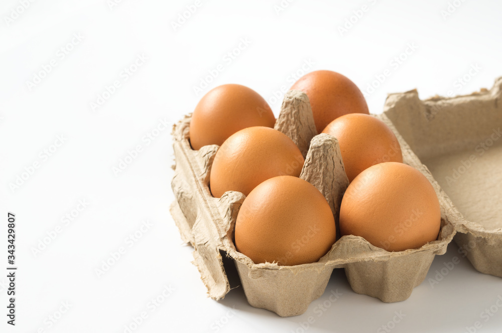 Eggs in carton box on white background.