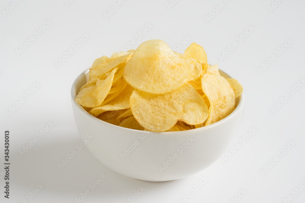 Potato chips in bowl on white background. Potato chips in bowl on white background.