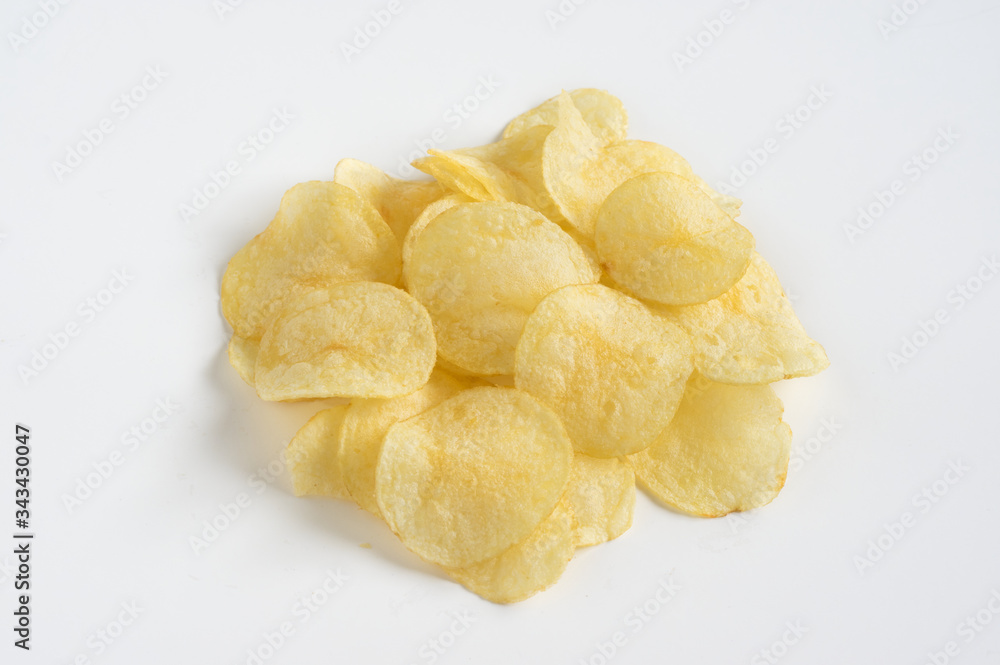 Stacked of potatoes chips on white table. Stacked of potatoes chips on white table.