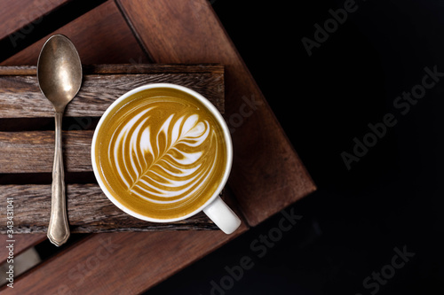 Tableau sur toile White cup of latte art barista cappuccino on a wooden table