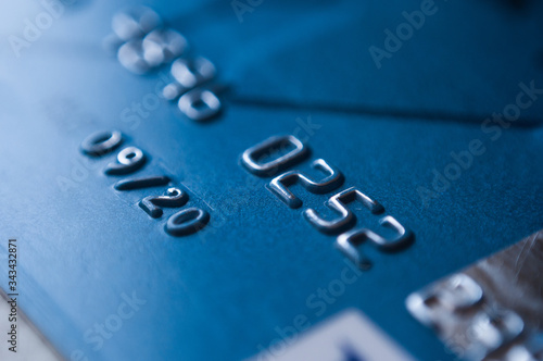 Credit card in blue tone. Selective focus. Low key macro shot with old credit card.