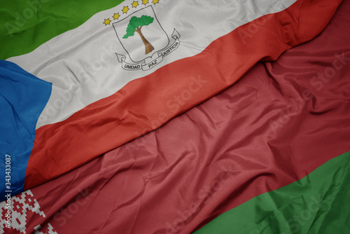 waving colorful flag of belarus and national flag of equatorial guinea.