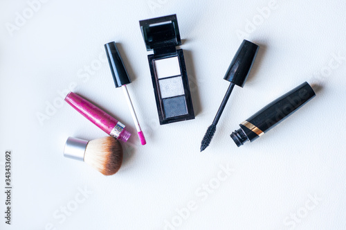 Close up view of various brushes and cosmetics for applying makeup on table