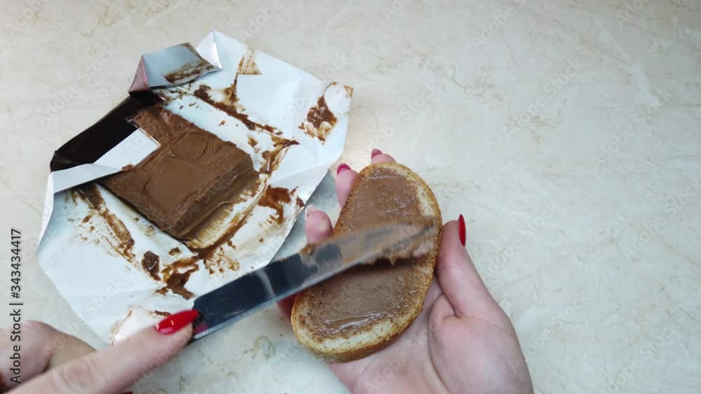 custom made wallpaper toronto digitalSlow motion girl spreading chocolate nut butter on ciabatta slice