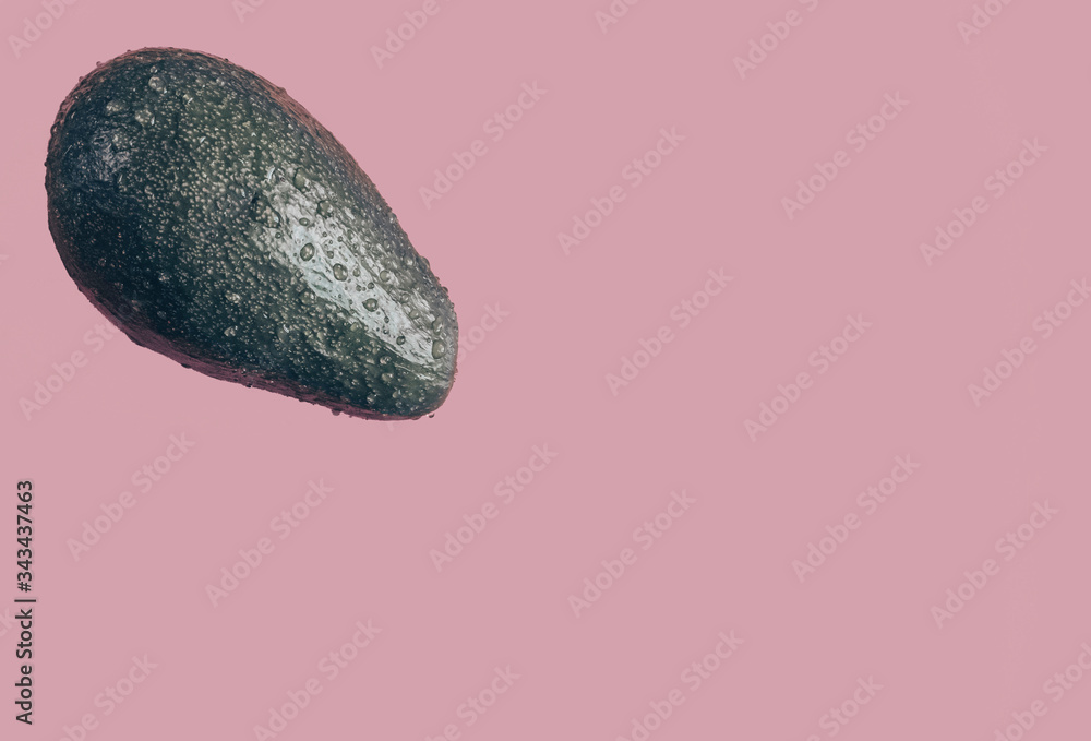 Avocado for the keto diet. Fresh avocado isolated on pink background closeup. Ripe fresh green avocado. Art green avocado. Avocado for the keto diet. Fresh avocado isolated on pink background closeup. Ripe fresh green avocado. Art green avocado.
