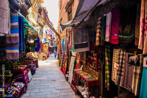 Market street shops, scarfs against Corona Virus, Bhaktapur, Nepal © Marco
