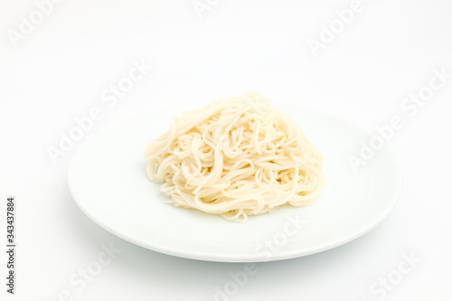 Noodles made of flour on a white background