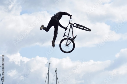 guy on bmx performing tricks in the air 