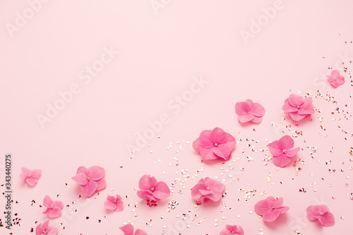 Pink flowers and gold confetti for Happy Mothers Day greeting card. Holiday background, copy space. Spring, summer, birthday.