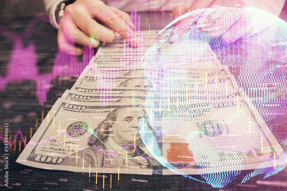 Multi exposure of forex graph drawing hologram and USA dollars bills and man hands. Technical Analysis concept. Multi exposure of forex graph drawing hologram and USA dollars bills and man hands. Technical Analysis concept.