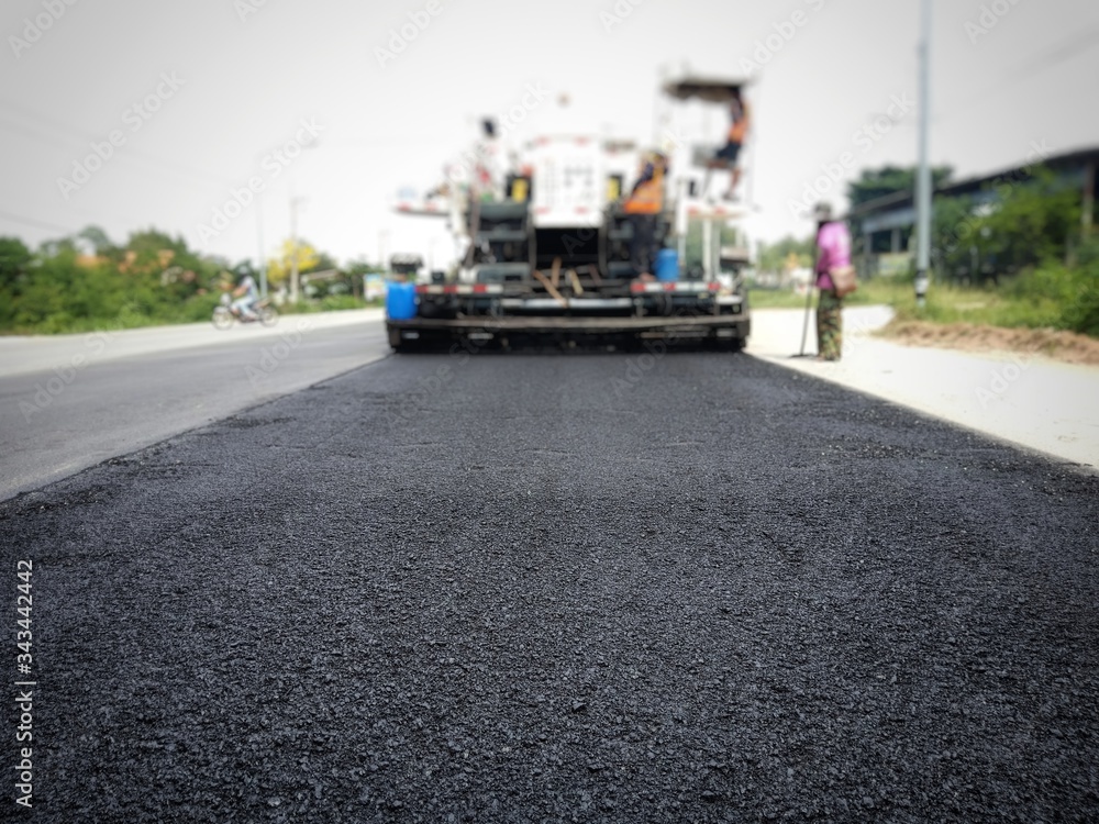 Road maintenance by the ASPHALT HOT MIX IN - PLACE RECYCLING (blurred image). Road maintenance by the ASPHALT HOT MIX IN - PLACE RECYCLING (blurred image).