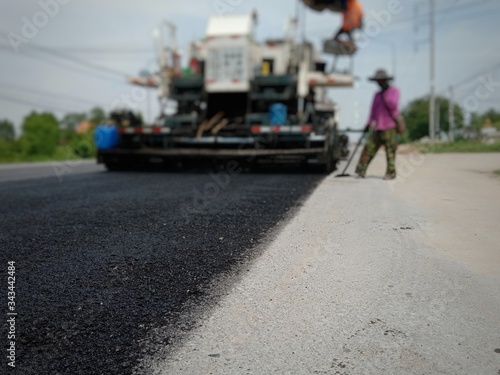 Road maintenance by the ASPHALT HOT MIX IN - PLACE RECYCLING (blurred image).