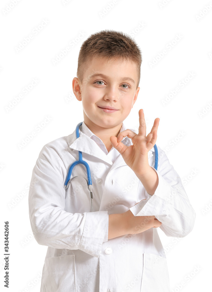 Cute little doctor showing OK gesture on white background Cute little doctor showing OK gesture on white background