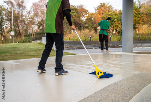  Man and woman Janitor Cleaning Floor With Mopping on modern building
