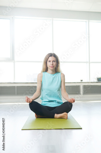 Beautiful woman doing yoga practice indoors